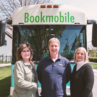 The Bookmobile staff posing in front of the bookmobile