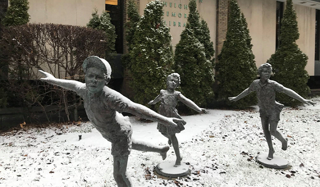 Image of three statues in front of the library.