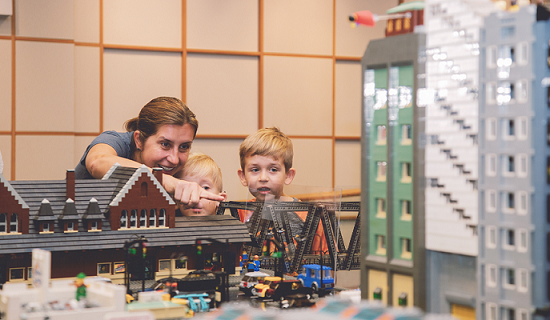 Family looking at the LEGO Train Exhibit