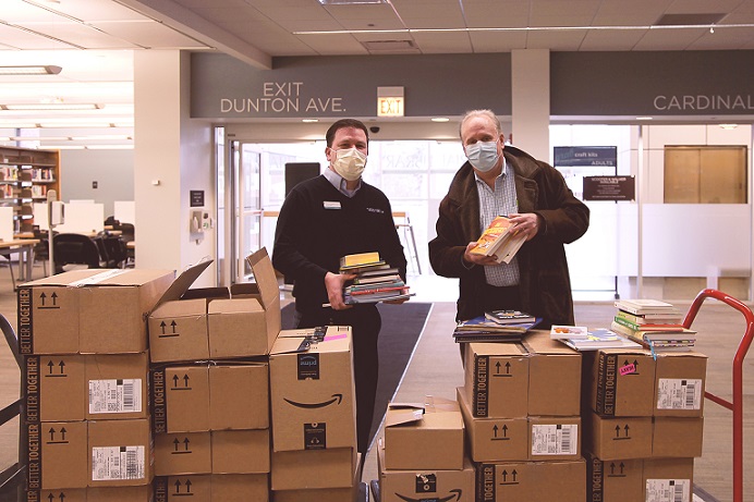 Photo of boxes of books with Mike Driskell and Wheeling Township