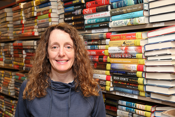 Leeanne Smith in front of a stack of books
