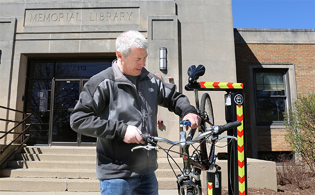 Arlington Heights resident John Beletti using the Bike Repair Station