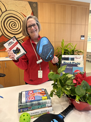 AHML Staff Member Holding Pickleball Set