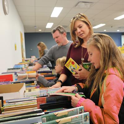 Image of woman and daughter buying books