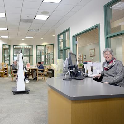 photo of staff and customers in senior center reading room