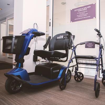 A photo of a scooter and chair walker by the dunton entrance