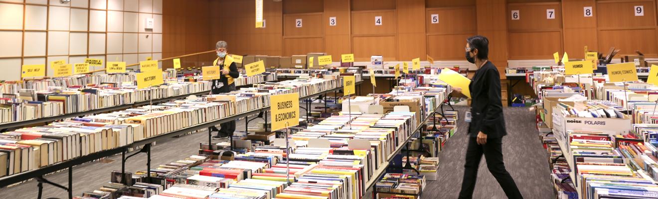 Two Friends of the Library Members setting up the Fall Booksale