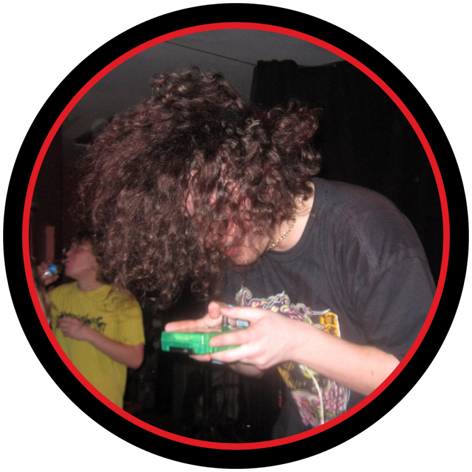 A photo of venoSci playing music on a game boy at a concert